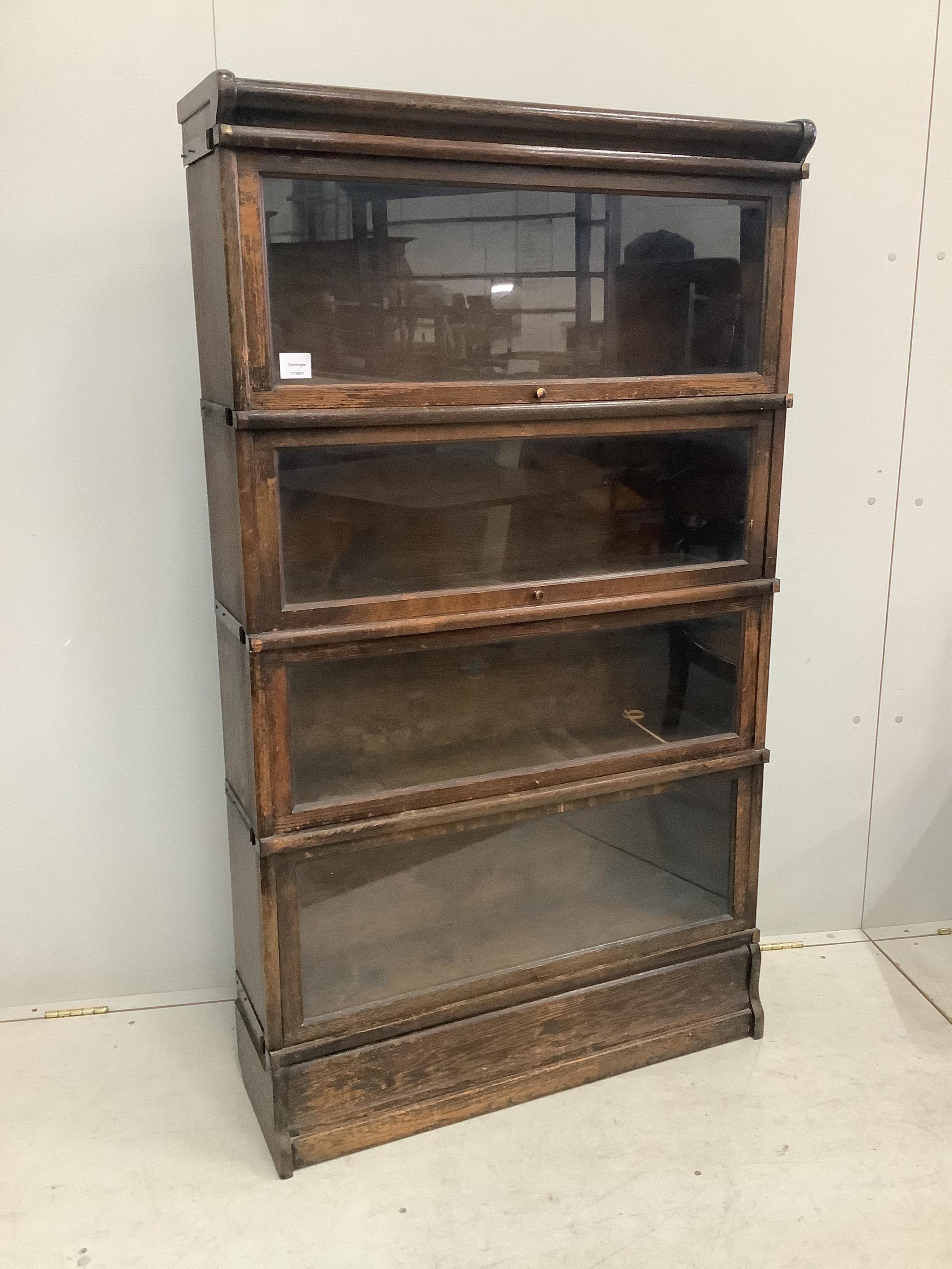 A Globe Wernicke oak four section bookcase, width 86cm, depth 27cm, height 151cm. Condition - fair